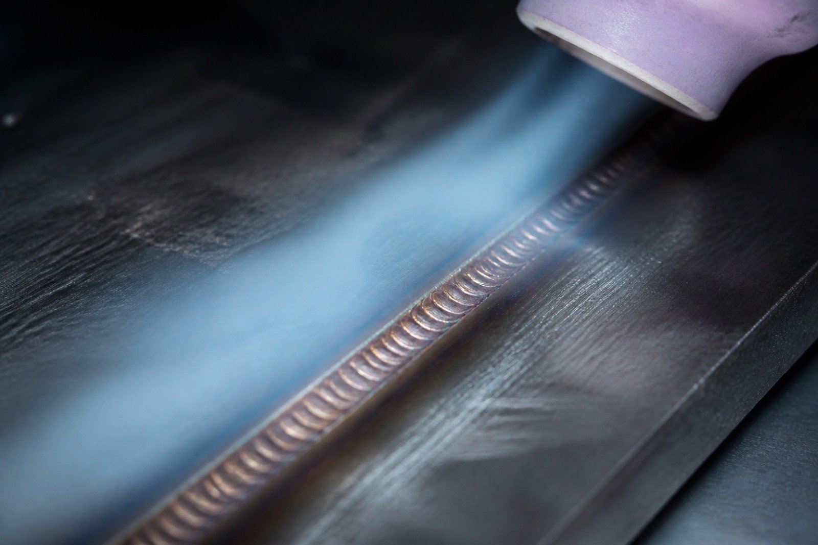Pale argon mist along a prepared metal seam